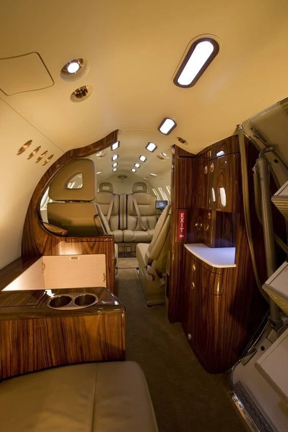 The wood-panelled cabin of a private jet