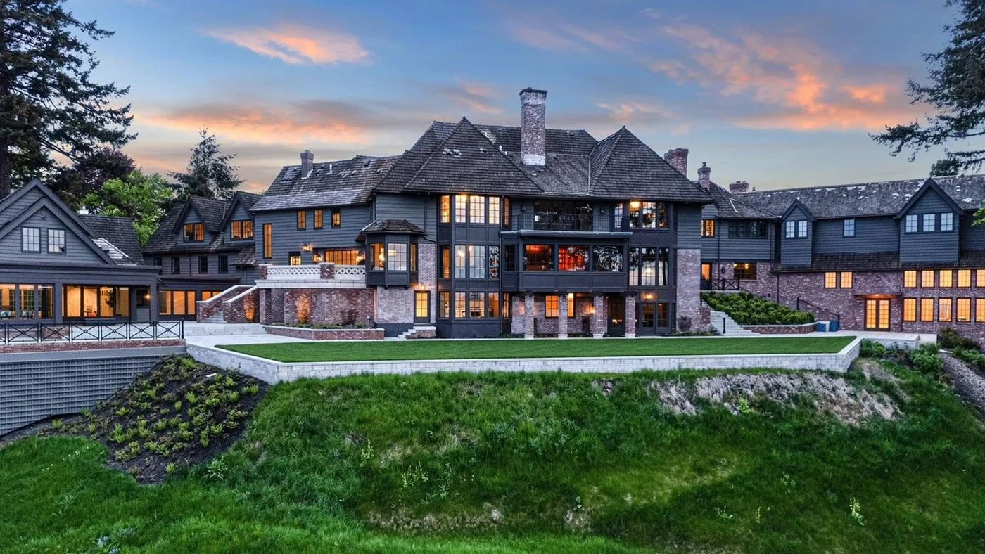 A country residence with lit windows at dusk